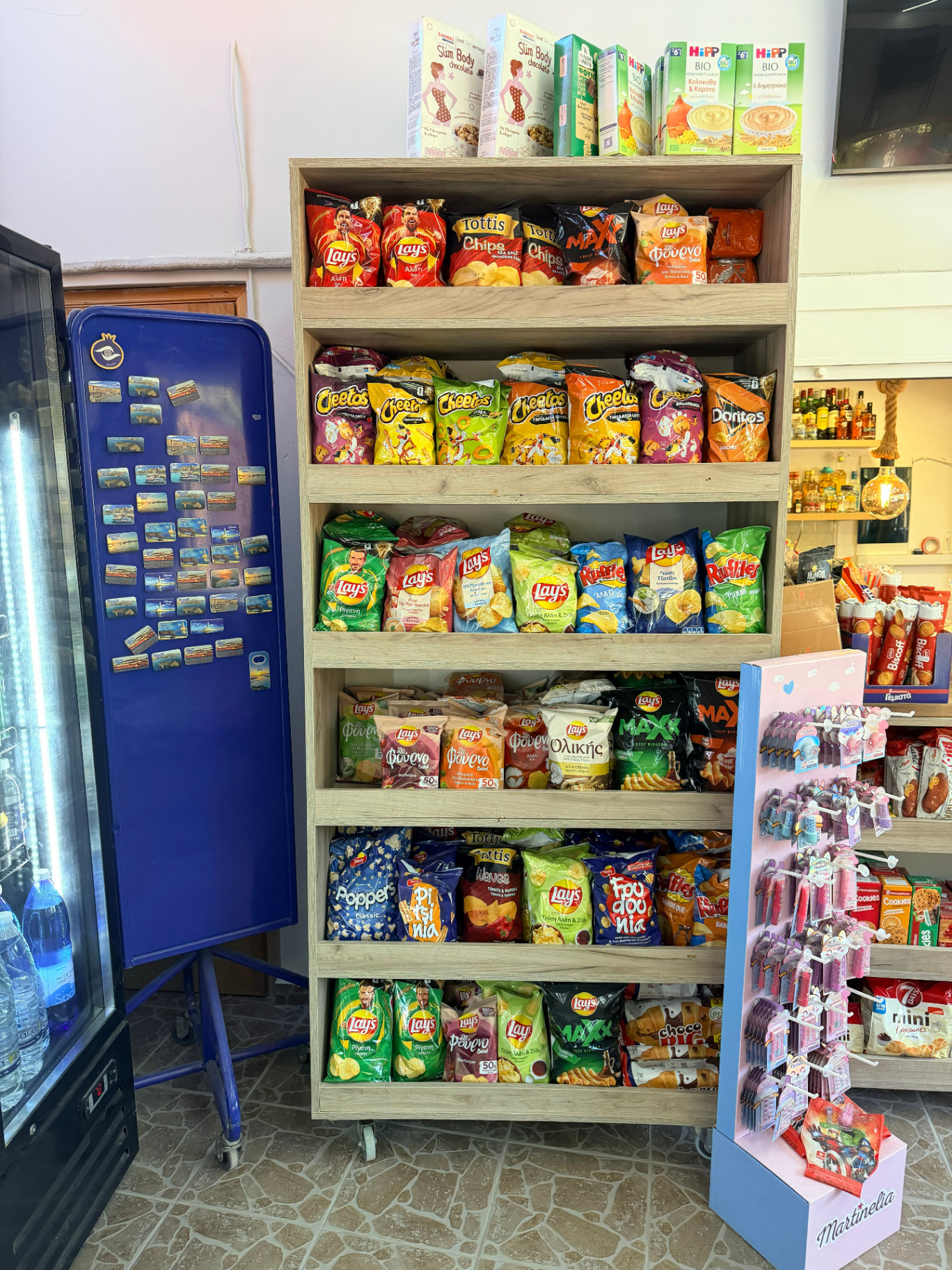 Chips shelf with Lays Ruffles Cheetos Doritos and Greek snacks at AMOS SEASIDE Mini Market Marathi Beach Chania