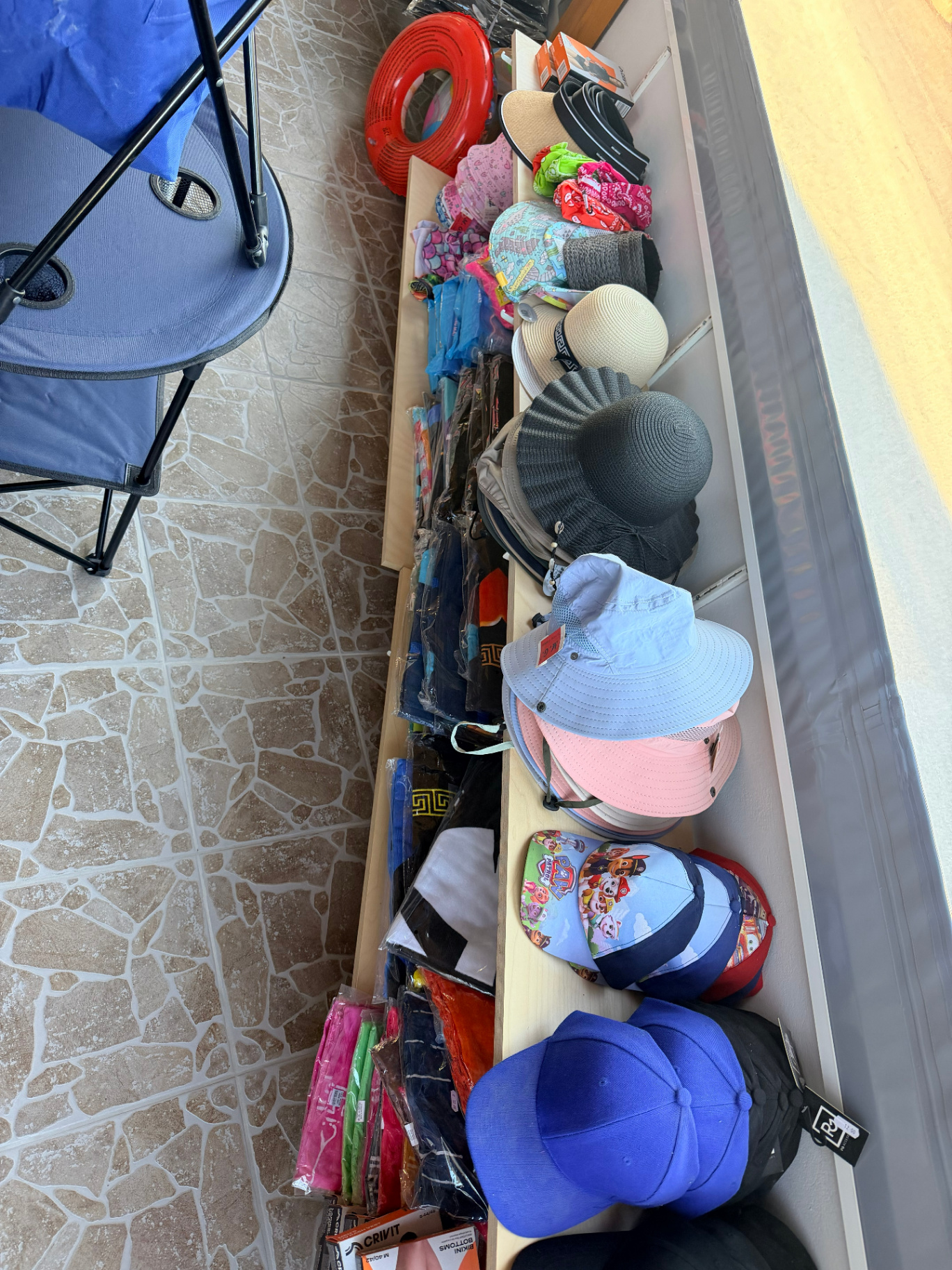 Sun hats straw hats and caps display at AMOS SEASIDE Mini Market Marathi Chania Crete