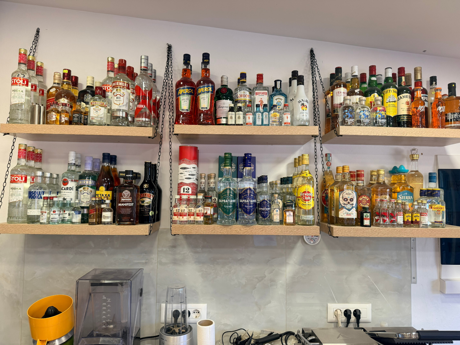Premium spirits shelf with vodka gin rum whisky and Cretan raki at AMOS SEASIDE Mini Market Marathi Chania